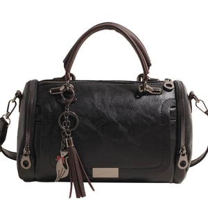 Fashion vintage black soft leather Boston bag with brown handles and a cat tassel pendant