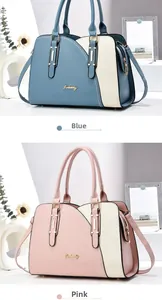 Detail view of stylish color-block handbags in blue and pink with gold tone hardware