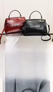 Detail of red and black wrinkled faux leather handbags with silver metal twist locks