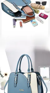 Detail showing high-capacity interior of color-block handbag with daily essentials