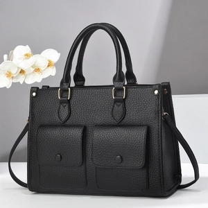 Minimalist black pebble leather tote bag with double front pockets and gold hardware