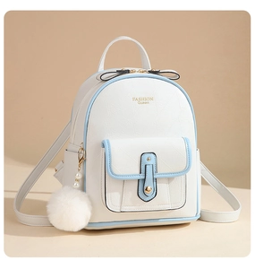 Front view of mini white PU backpack with blue trim, bow decor, and plush pompom charm