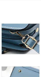 Detail of Morandi blue leather bag with gold-tone hardware and precision stitching