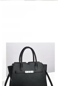 Detail of black pebbled leather handbag with silver metallic hardware and top handles