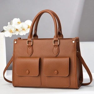 Brown lychee grain tote bag with dual front pockets and adjustable crossbody strap