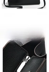 Detail of silver zipper hardware and black pebble grain leather on a stylish handbag