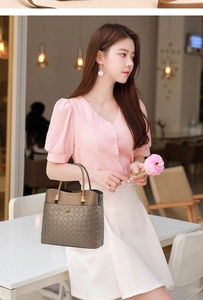 Detail of a brown woven bucket bag in smooth leather and checkered texture for women