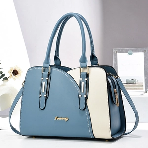 Contrast color handbag in blue and white faux leather with double handles and shoulder strap