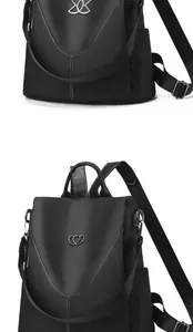 Détail du sac à dos noir avec boucle en cœur argentée et surpiqûres blanches