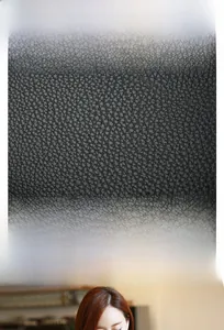 Detailed close-up showing the premium black lychee texture PU leather of the Kelly handbag