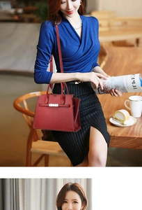 Detail of red leather crossbody bag with silver metal lock and detachable strap