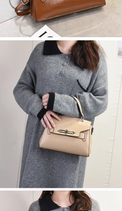 Detail of beige faux leather handbag featuring a stylish metal lock and flap closure
