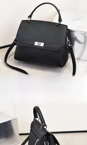Detailansichten einer schwarzen Handtasche mit Litschi-Muster und silbernem Drehverschluss