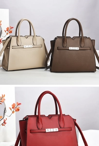 Close-up of luxury leather Kelly bag in beige, brown and red with silver metal clasp