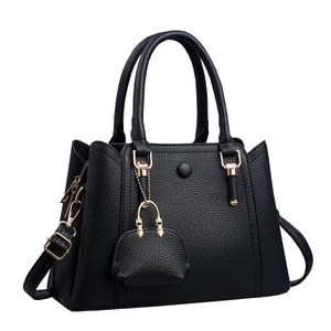Fashionable black lychee grain leather tote bag with gold hardware and mini charm