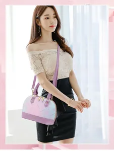 Detail of floral printed crossbody bag in gradient purple and blue with long shoulder strap