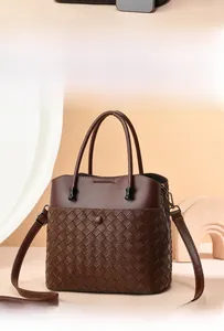 Detailed view of dark brown woven leather texture and premium smooth finish on a tote bag