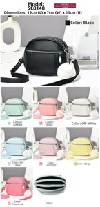 Compact three-layer zipper crossbody bag with litchi texture and white fur ball pendant