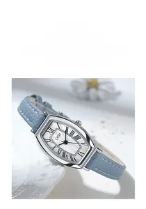 Macro detail of tonneau quartz watch with Roman numerals and blue textured strap