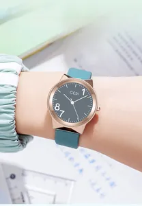 Close-up of GEDI rose gold watch with dark grey dial and teal silicone strap on wrist