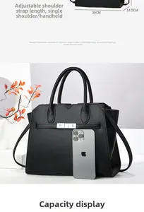Macro shot of black lychee leather bag with silver metal buckle and iPhone size reference