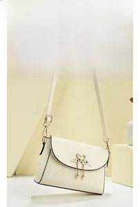 Detail of off-white crossbody bag with flamingo heart clasp and pearl pendants