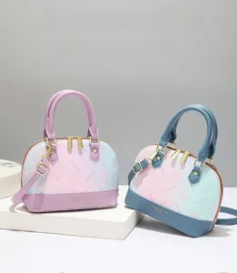Detail of shell-shaped gradient floral handbags with double handles and gold hardware