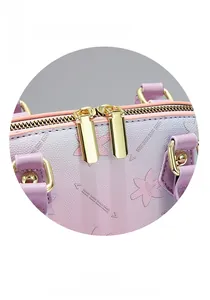 Detail of gradient semi-circle bag with floral embossing and polished gold metal hardware