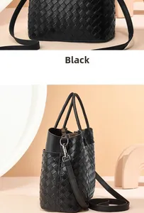 Detailed view of black woven leather texture and silver hardware on a versatile tote bag