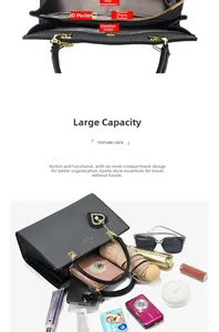 Detail view showing multi-pocket interior storage and gold heart charm on black tote bag