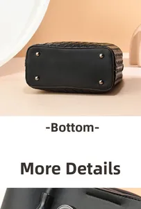 Detail view of woven leather tote bag bottom with protective metal studs in black