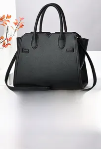 Detailed view of black lychee grain leather handbag showing texture and side strap detail