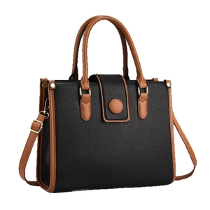 Classic black and brown tote bag with quilted texture and golden hardware details