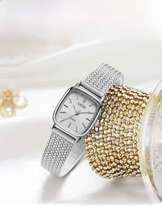 Detail of GEDI square dial watch with silver mesh strap on silk and gold luxury base