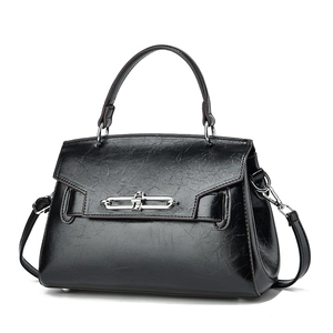 Classic black leather shoulder bag with top handle and metallic chain buckle closure