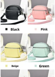 Detailed view of textured crossbody bags in four colors with wide straps and fur ball charms