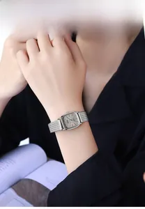 Close-up of a vintage silver mesh watch for women on a wrist against a soft background