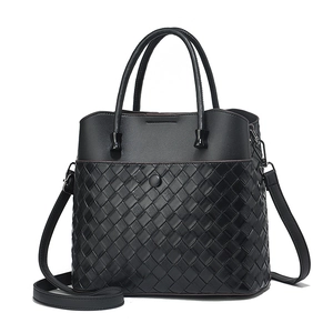 Large black woven leather tote bag with smooth top finish and adjustable shoulder strap