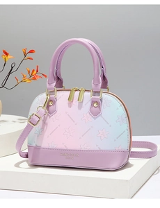 Detail of floral texture and gradient purple shell bag with golden metal zipper and strap