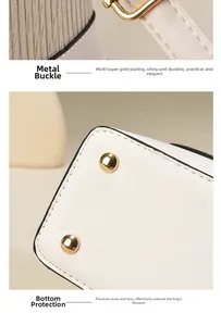 Détail de la boucle dorée et des clous de protection sur le sac à main en cuir beige