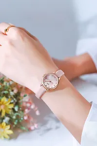 Fashionable women's watch with pink leather strap and rose gold case on model wrist
