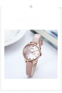 Detail of rose gold quartz watch with pink leather strap and sparkling starry dial