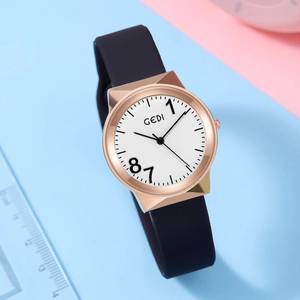 GEDI quartz watch with rose gold case, black silicone strap on a pastel background