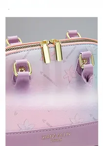 Detail of premium golden double zipper and embossed floral pattern on pink gradient bag