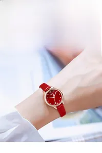 Close-up of GEDI fashion watch with red leather strap and sparkling rose gold dial