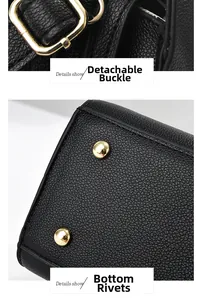 Detail of detachable gold buckle and anti-wear bottom rivets on black leather handbag
