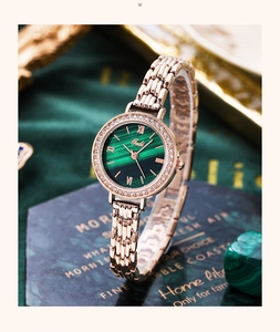 Macro shot of rose gold watch band and green malachite dial with diamond bezel