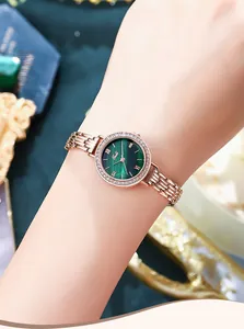 Detail of rose gold ladies' watch with green malachite dial and crystal bezel