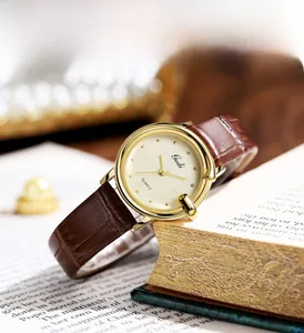 Detail of Gedi vintage quartz watch with brown leather strap resting on a book