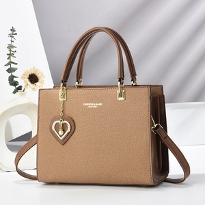 Brown leather and fabric tote bag with fashion text and heart pearl charm detail